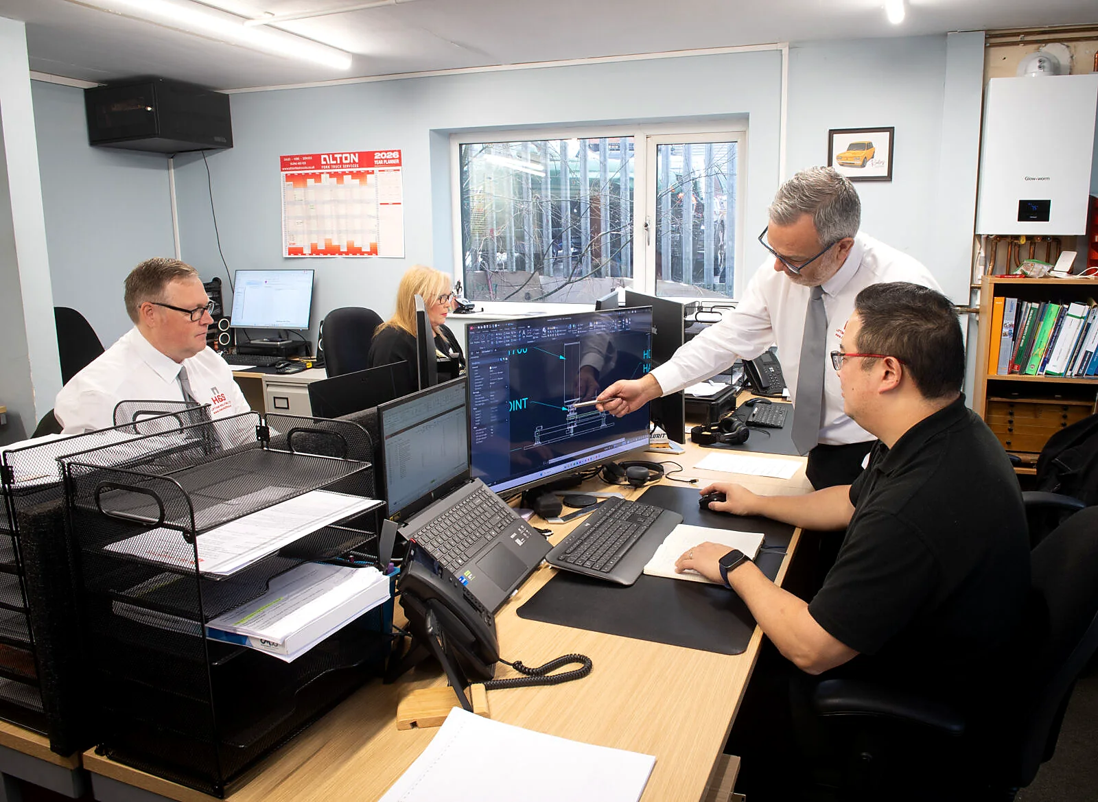 H&S Lifting team discussing servicing support.