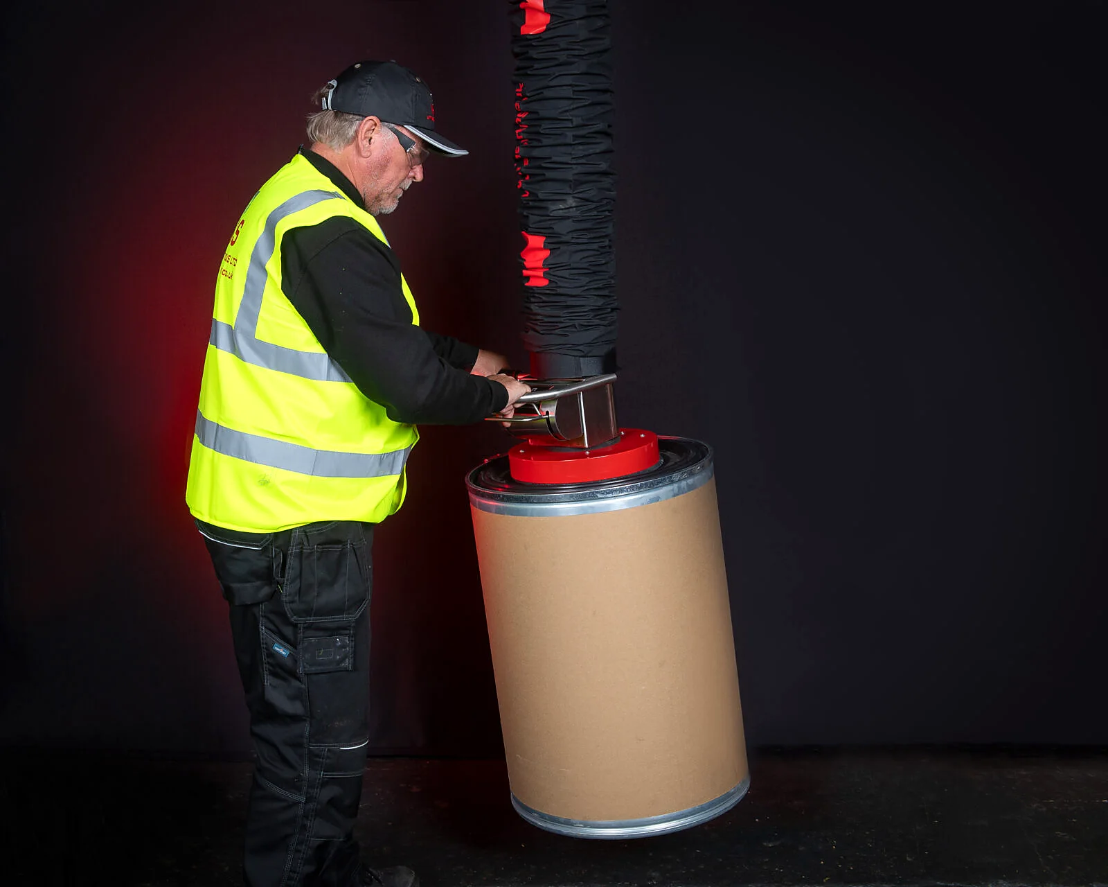 Vacuum drum lifter handling a drum.