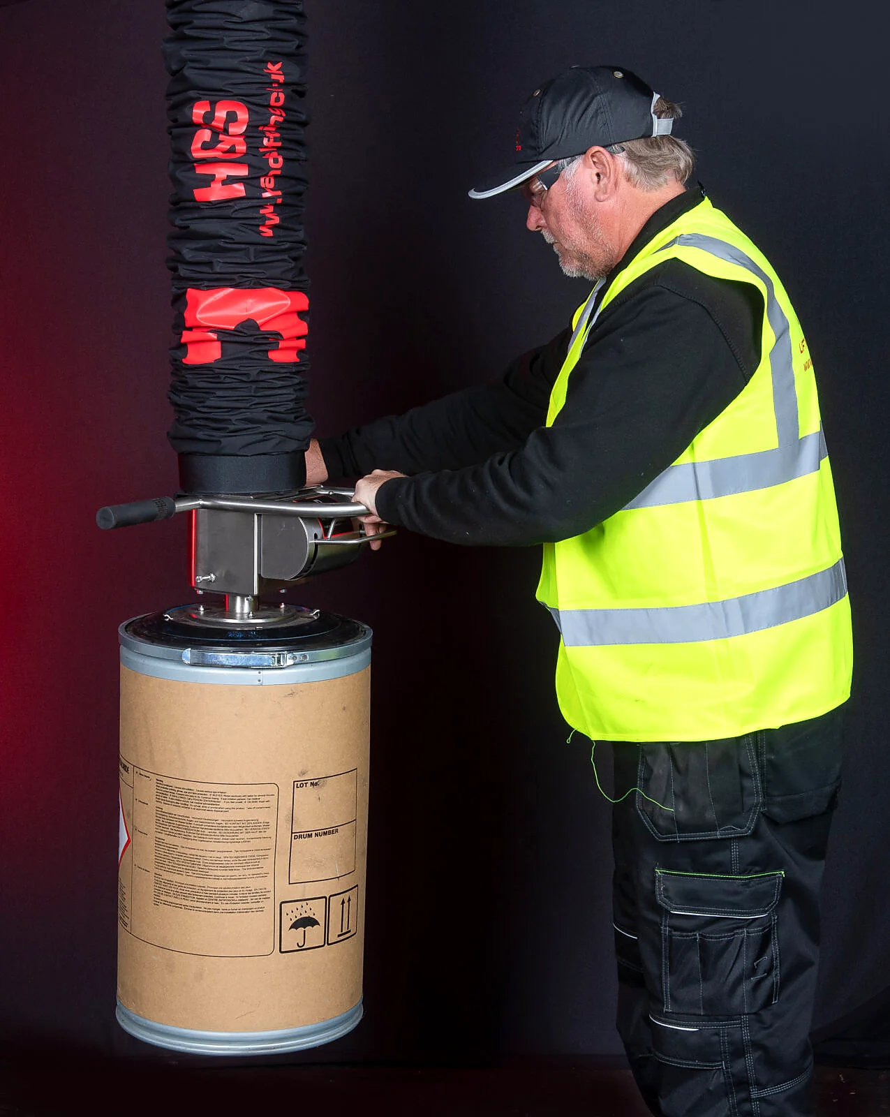 Vacuum drum lifting system with operator controls.
