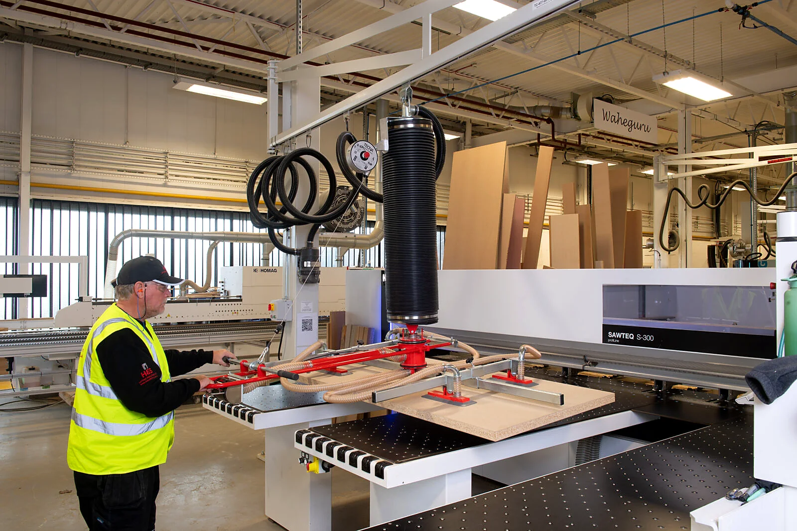 Vacuum board lifter used for industrial product handling.