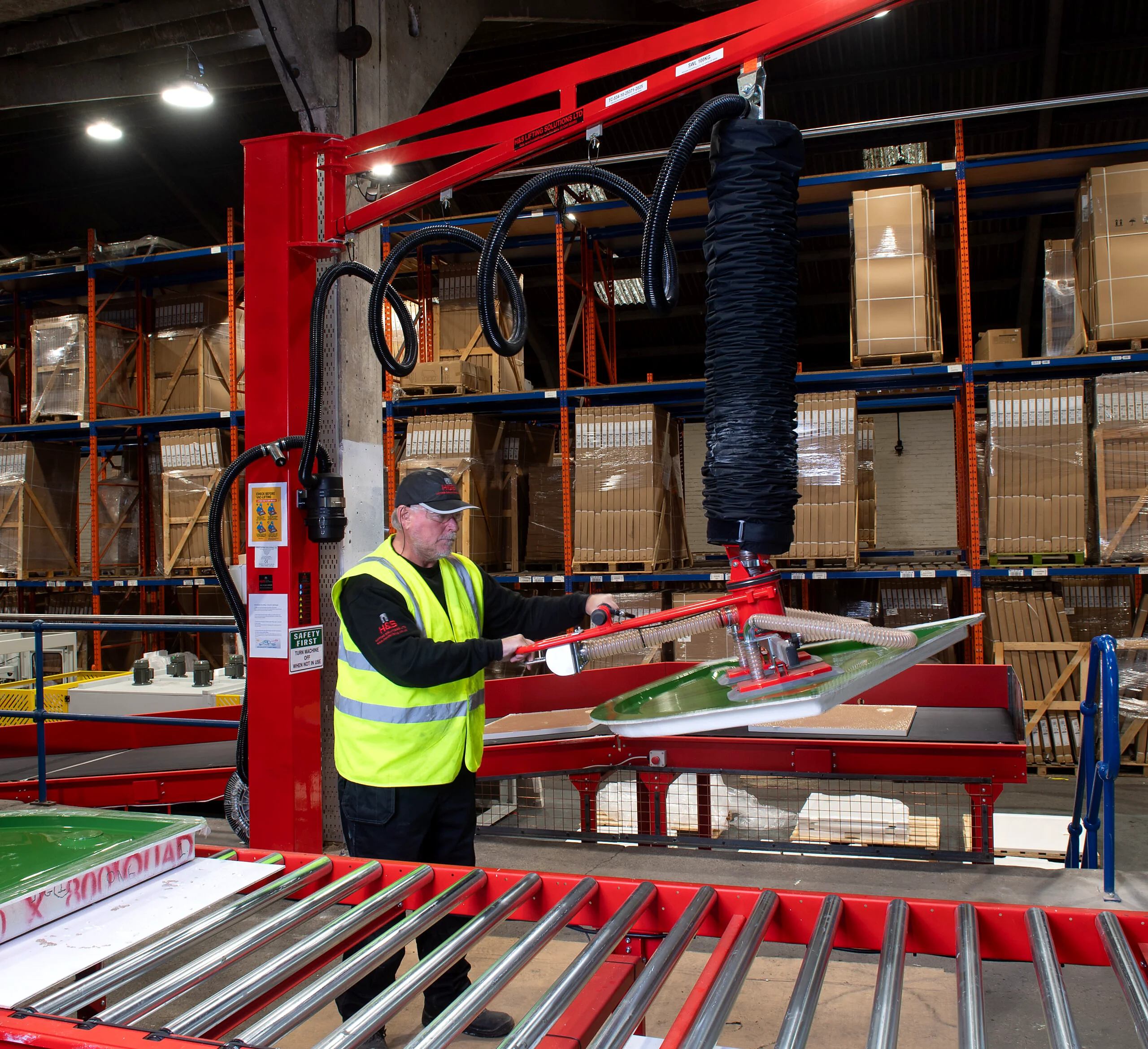Industrial lifting system with jib crane support.